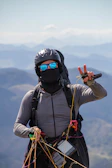 Close-up of a smiling pilot preparing a paraglider wing before takeoff.