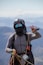 a man in a helmet and goggles holds up a pair of skis