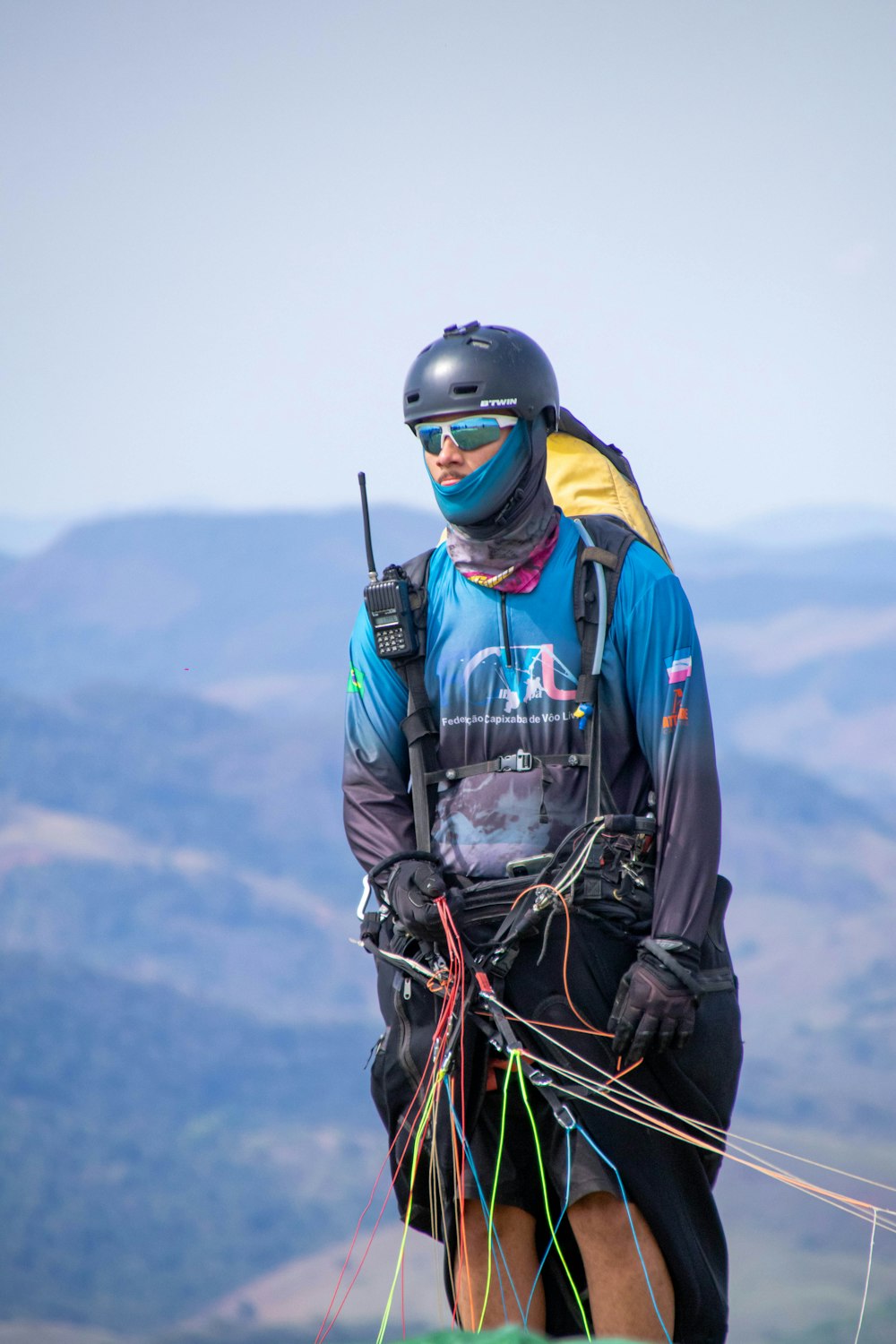 a man with a helmet and goggles holding a rope