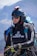 a man in a wet suit carrying a parachute