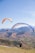 two people are paragliding over a mountain range