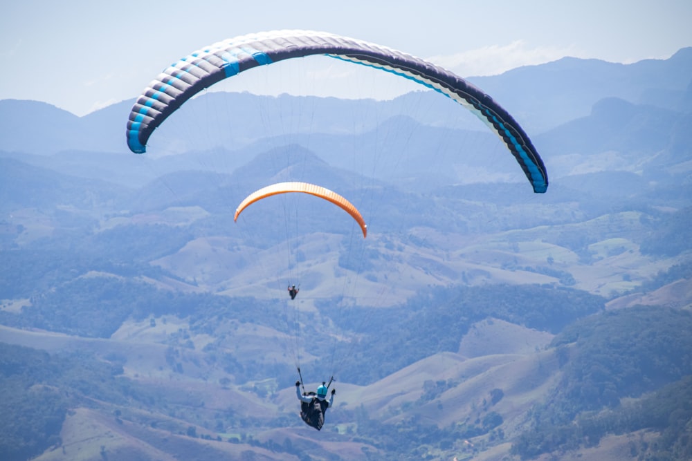 a paraglider is in the air with a parachute