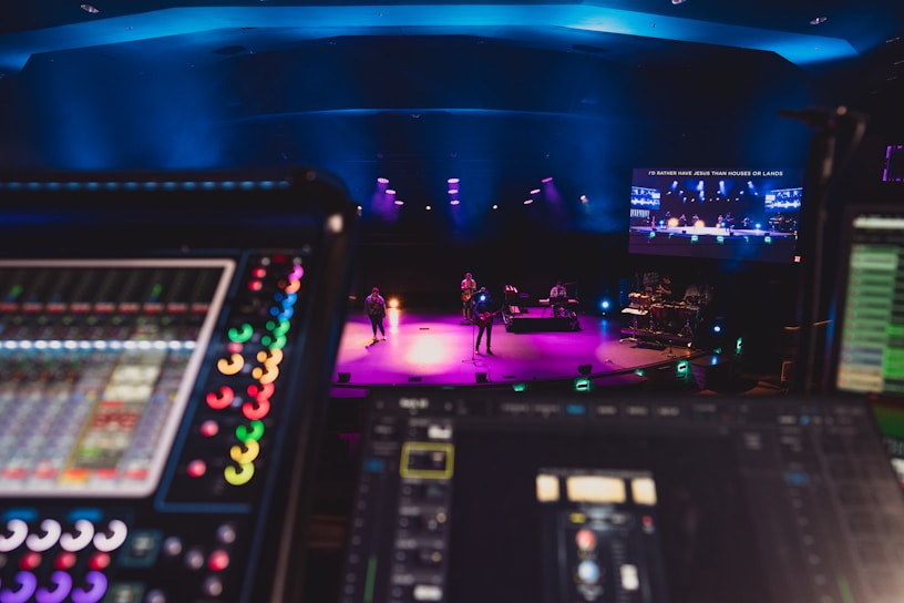 A vibrant stage setup with colorful lighting and professional sound equipment in action.