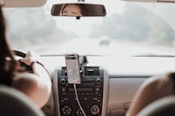A driver using a smartphone for navigation during a ride.