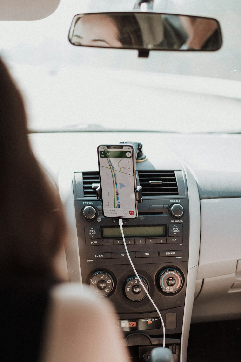 a car dashboard with a cell phone hooked up to it