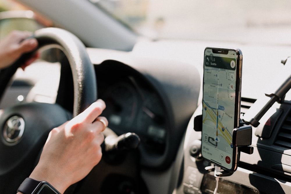 a person using a cell phone while driving a car