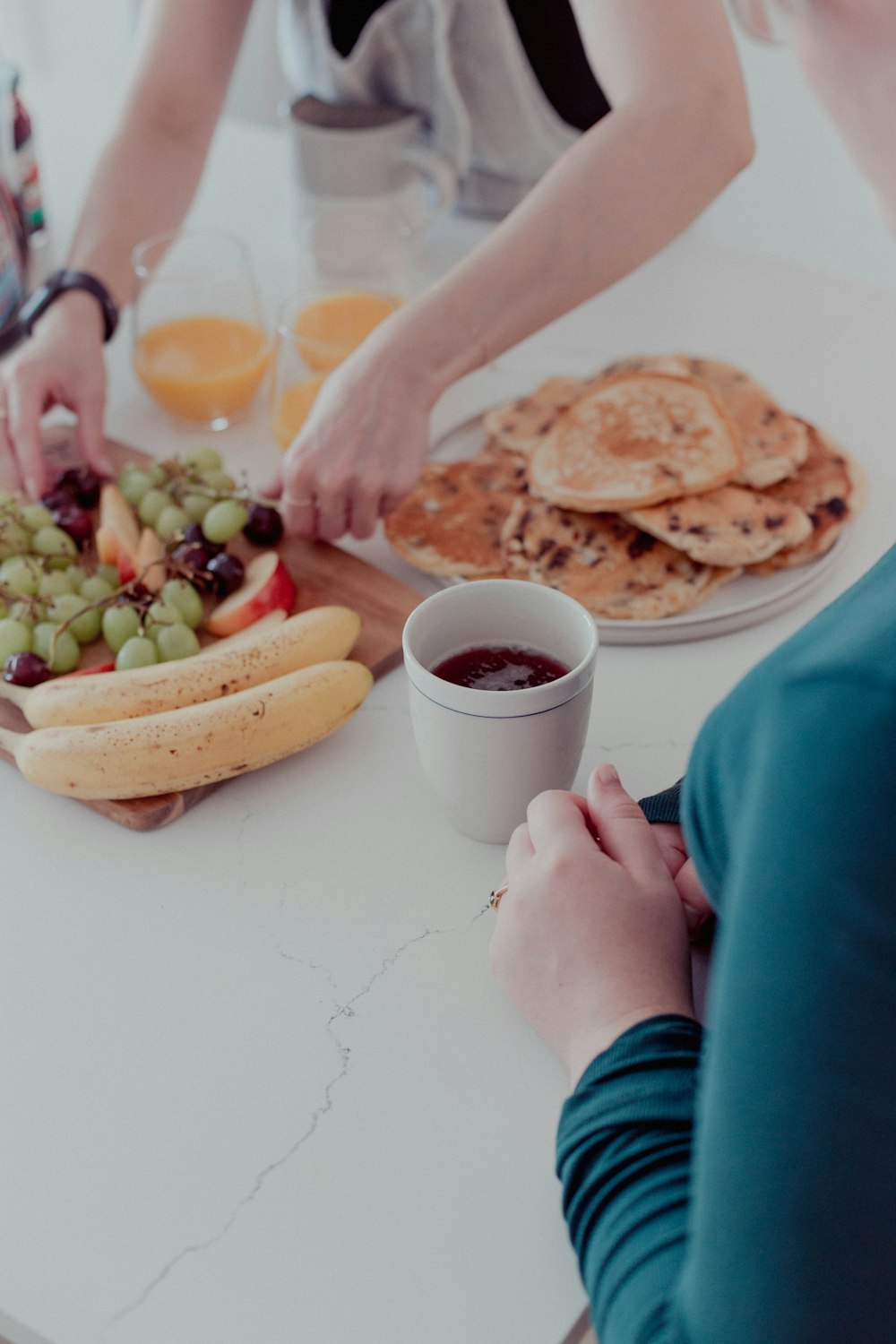 a couple of people sitting at a table with food