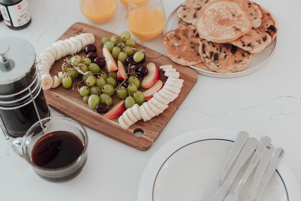 a table topped with plates of food and drinks