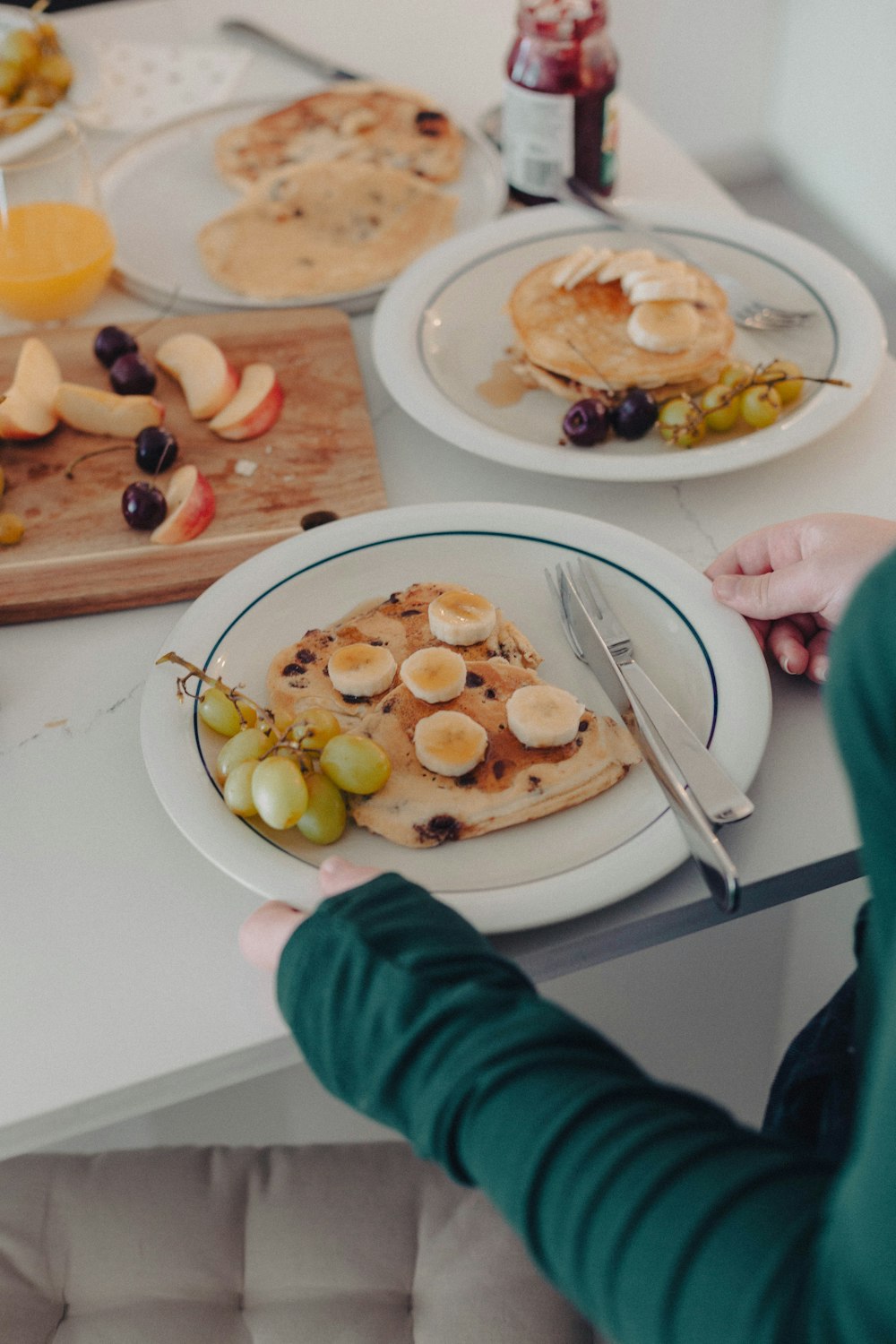 a person sitting at a table with a plate of food