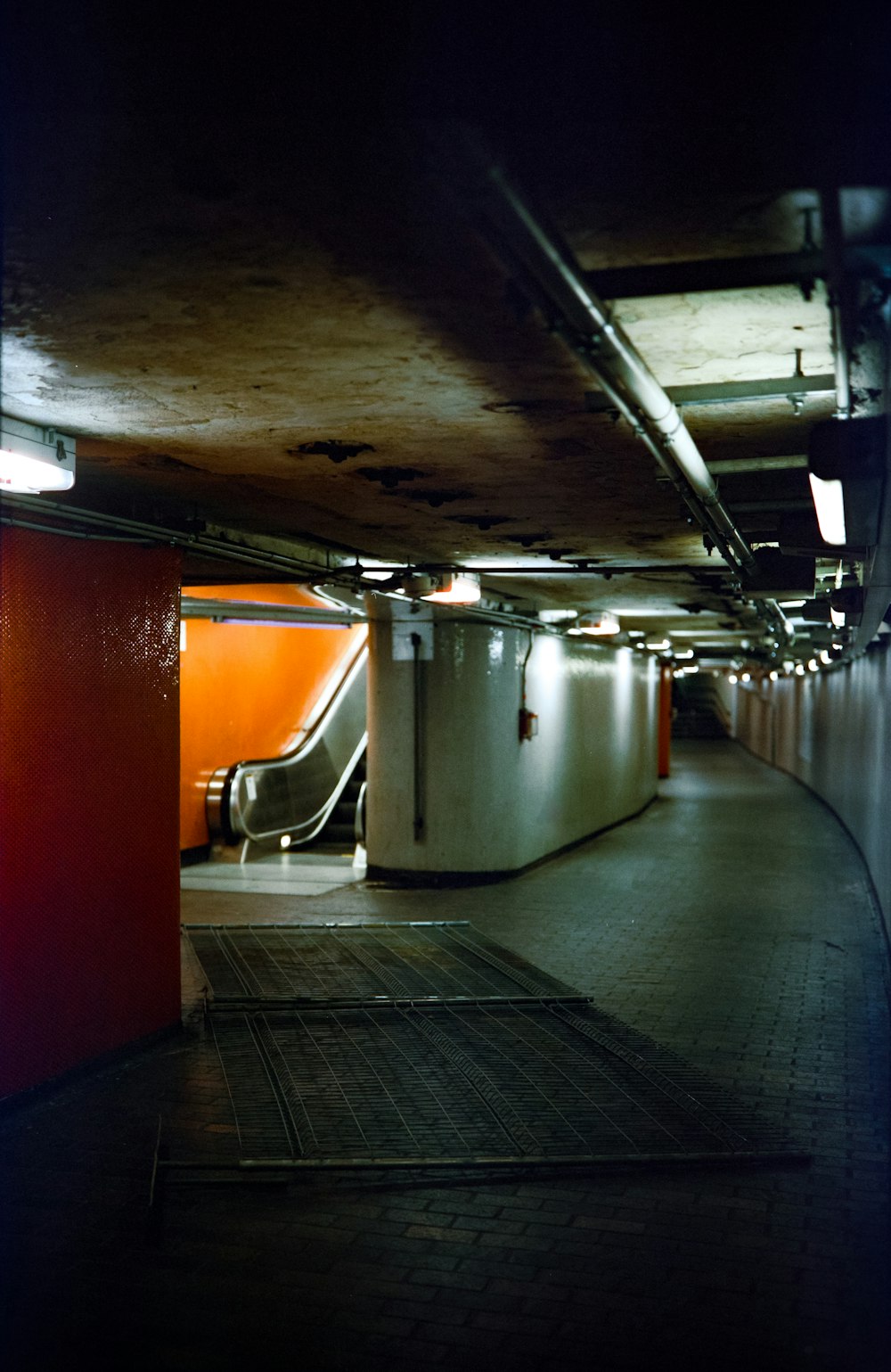 an empty parking garage with an escalator and stairs