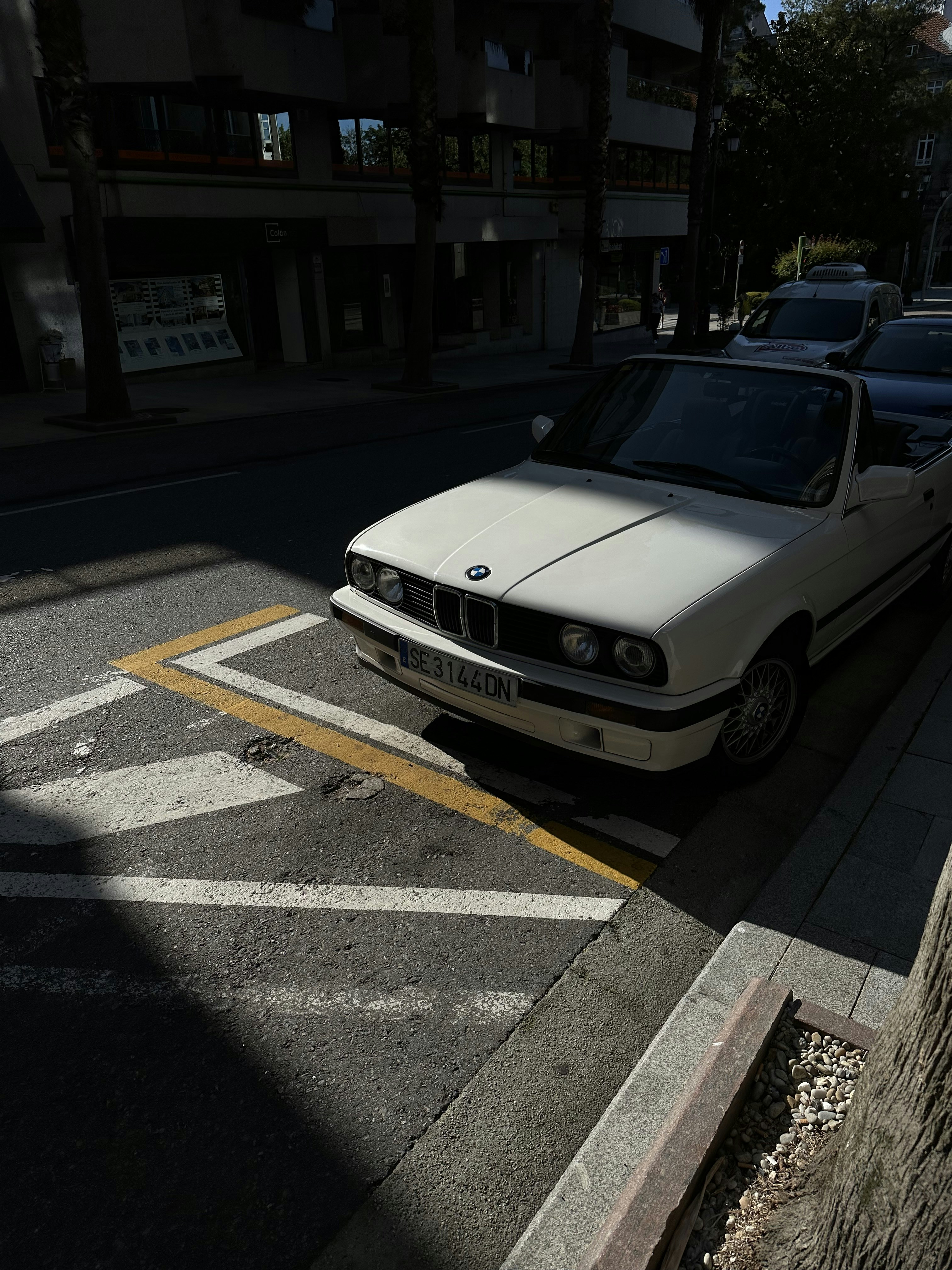 a white car parked on the side of the road