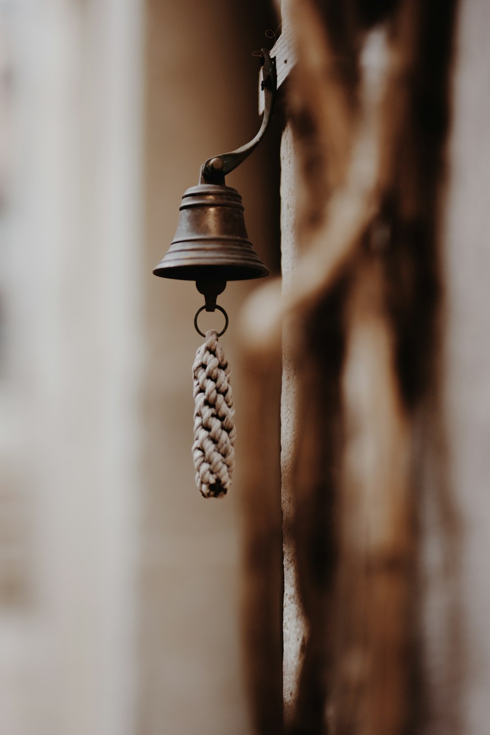 a bell hanging from the side of a building