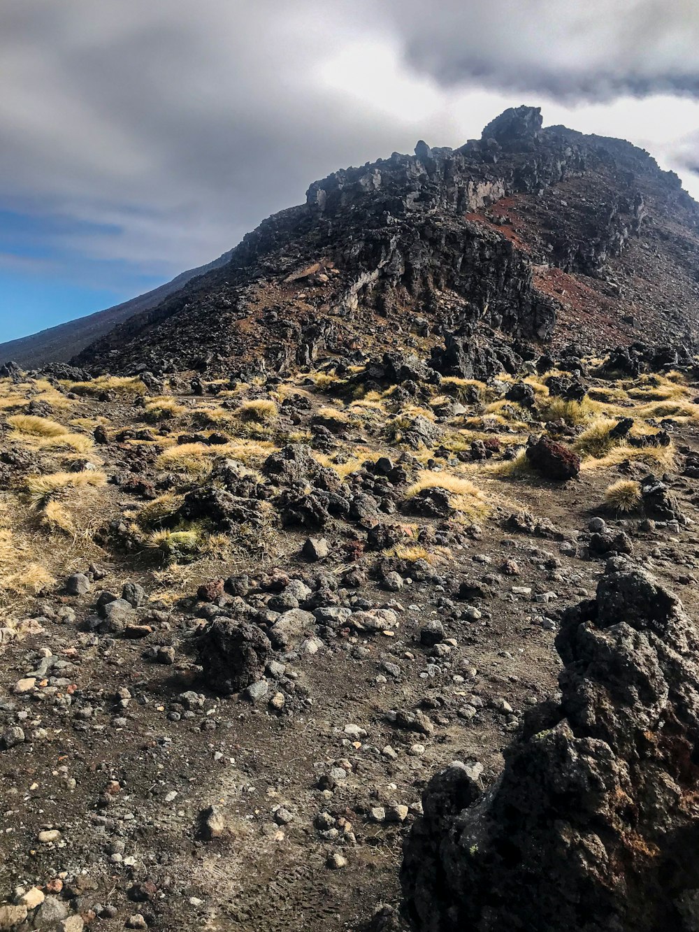 a mountain with a very tall rock on top of it