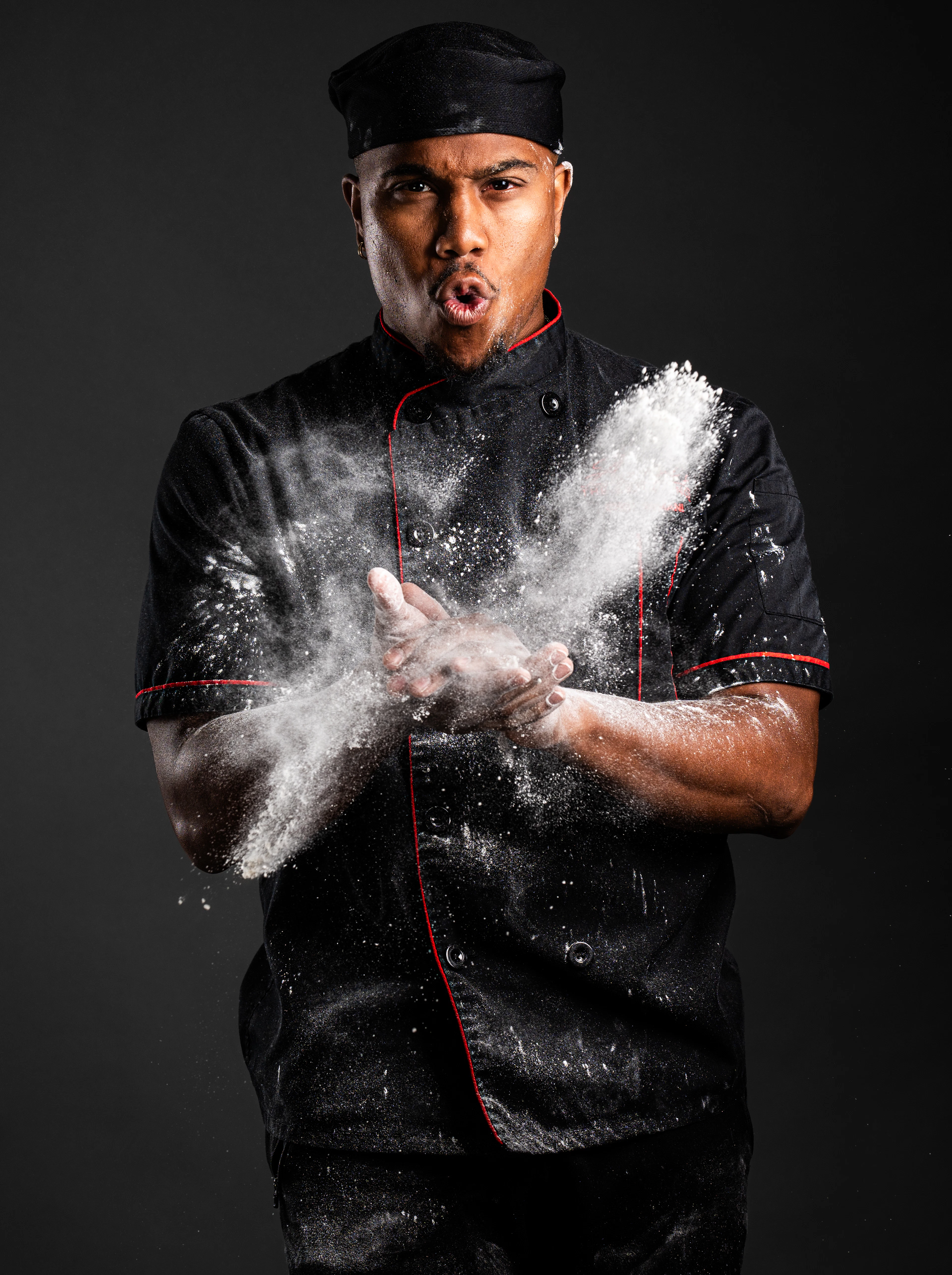 A chef dusted with flour at work
