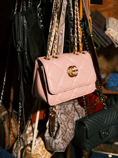 a bunch of purses hanging from a rack