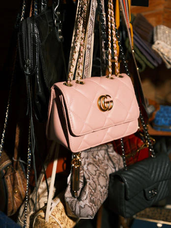 a bunch of purses hanging from a rack