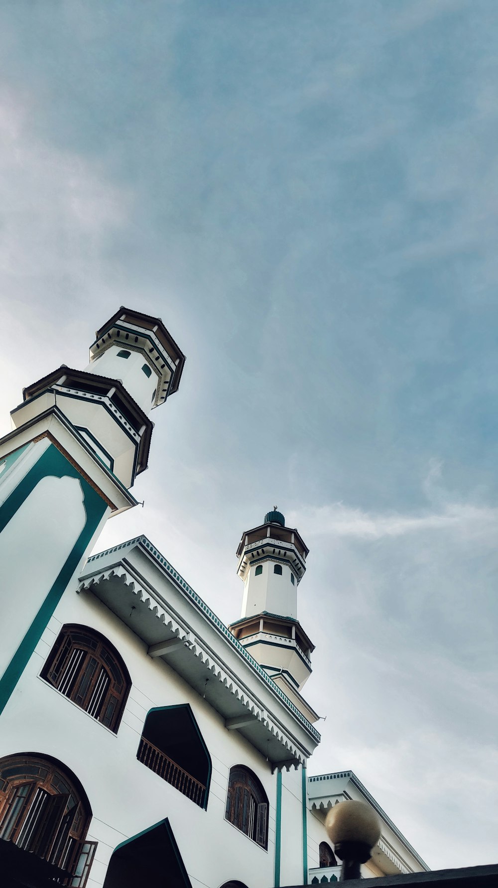 a tall white building with a clock on it's side