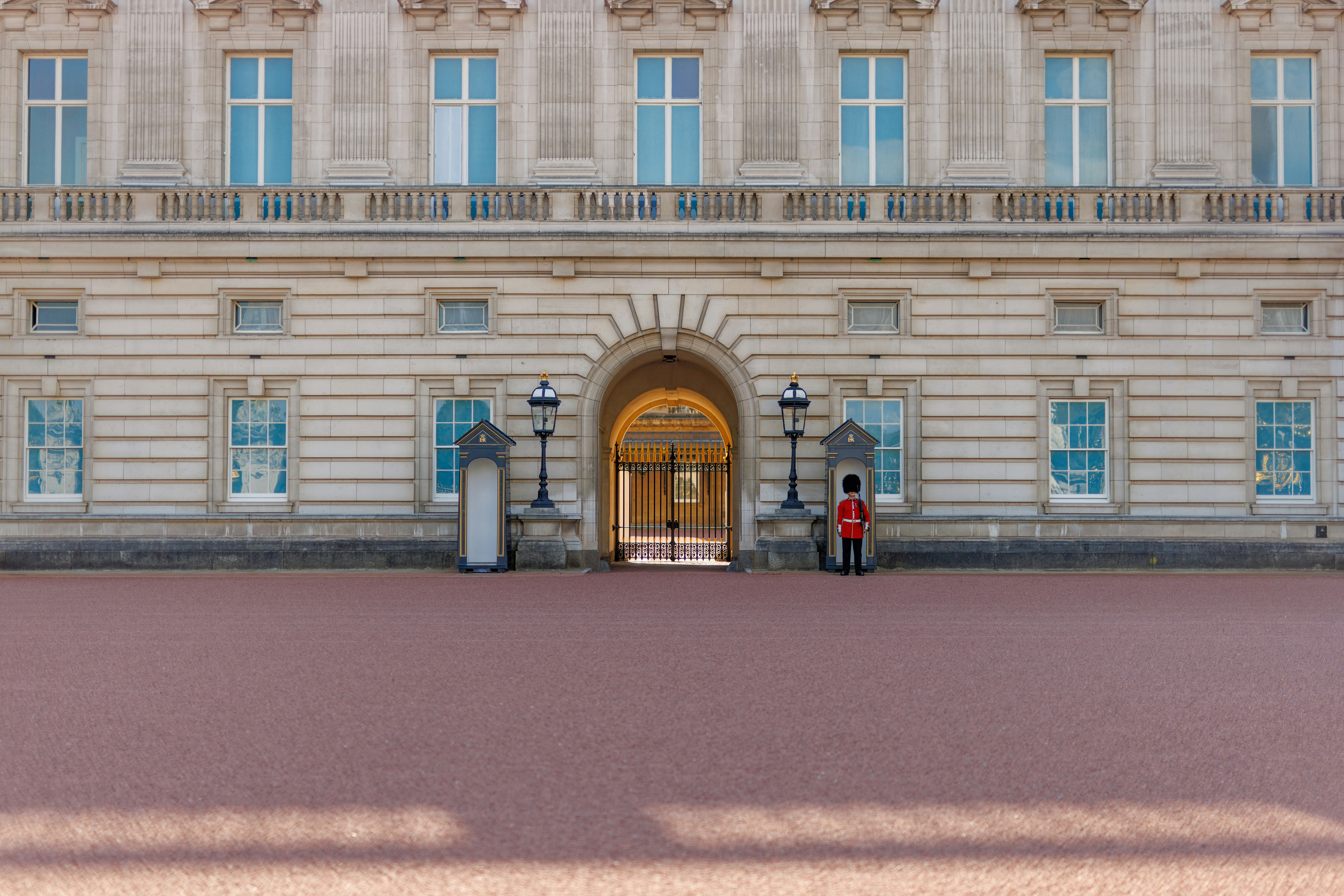 two people standing in front of a large building