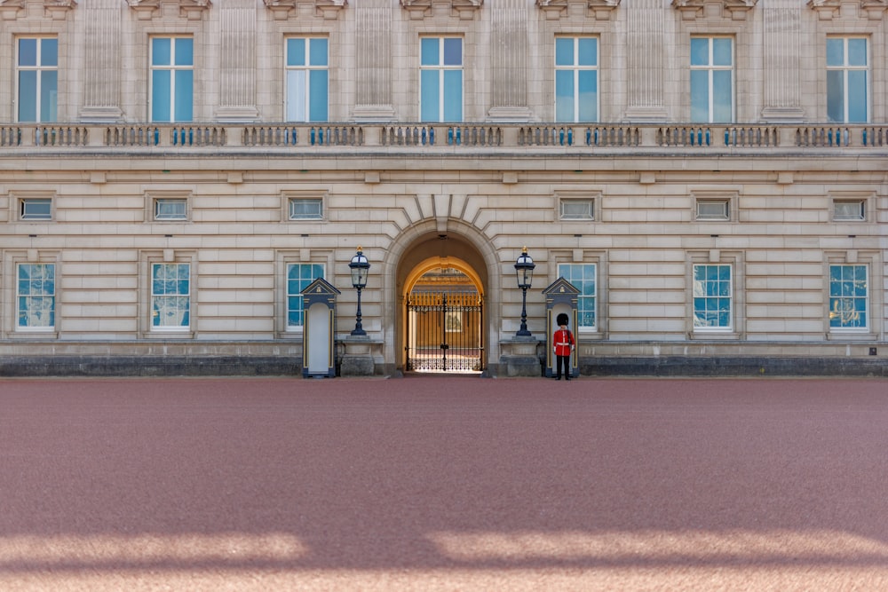 two people standing in front of a large building