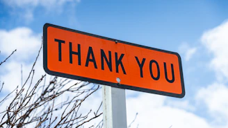 Customer handing a thank you note to a smiling technician after same-day garage door cable repair service.