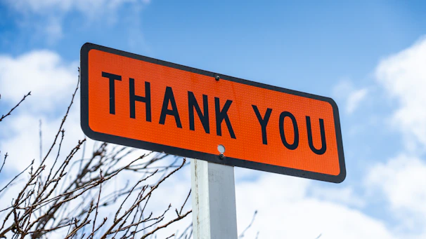 Customer handing a thank you note to a smiling technician after same-day garage door cable repair service.