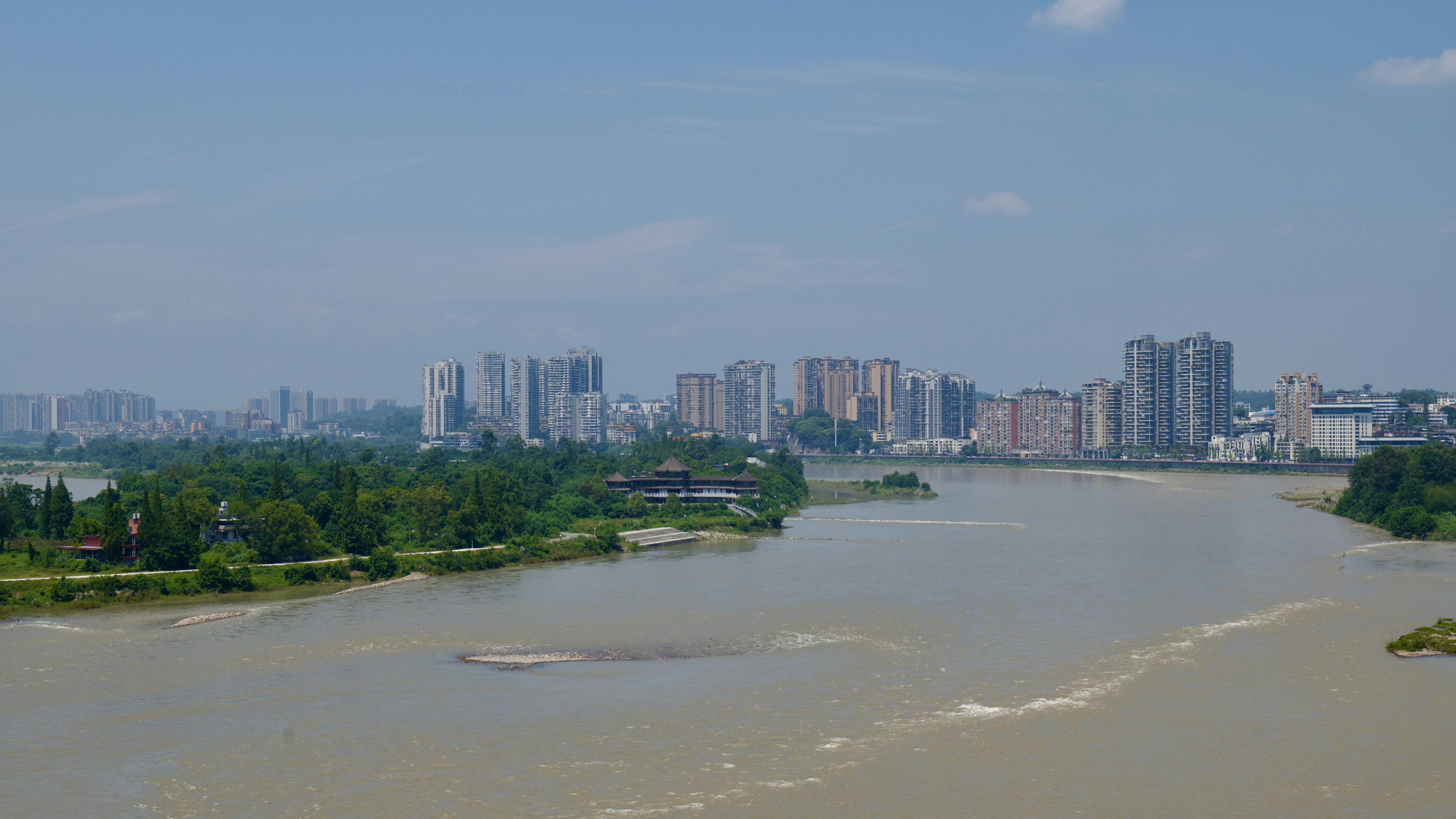 a large body of water with a city in the background