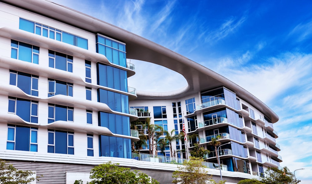 a large white building with blue windows on a sunny day