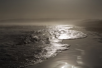 Waves gently lapping against the hull of a ship anchored near the shore.