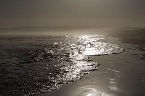 Waves gently lapping against the hull of a ship anchored near the shore.