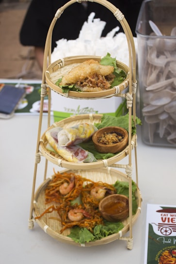 A vibrant display of Vietnamese vegetarian dishes including noodles and cakes.
