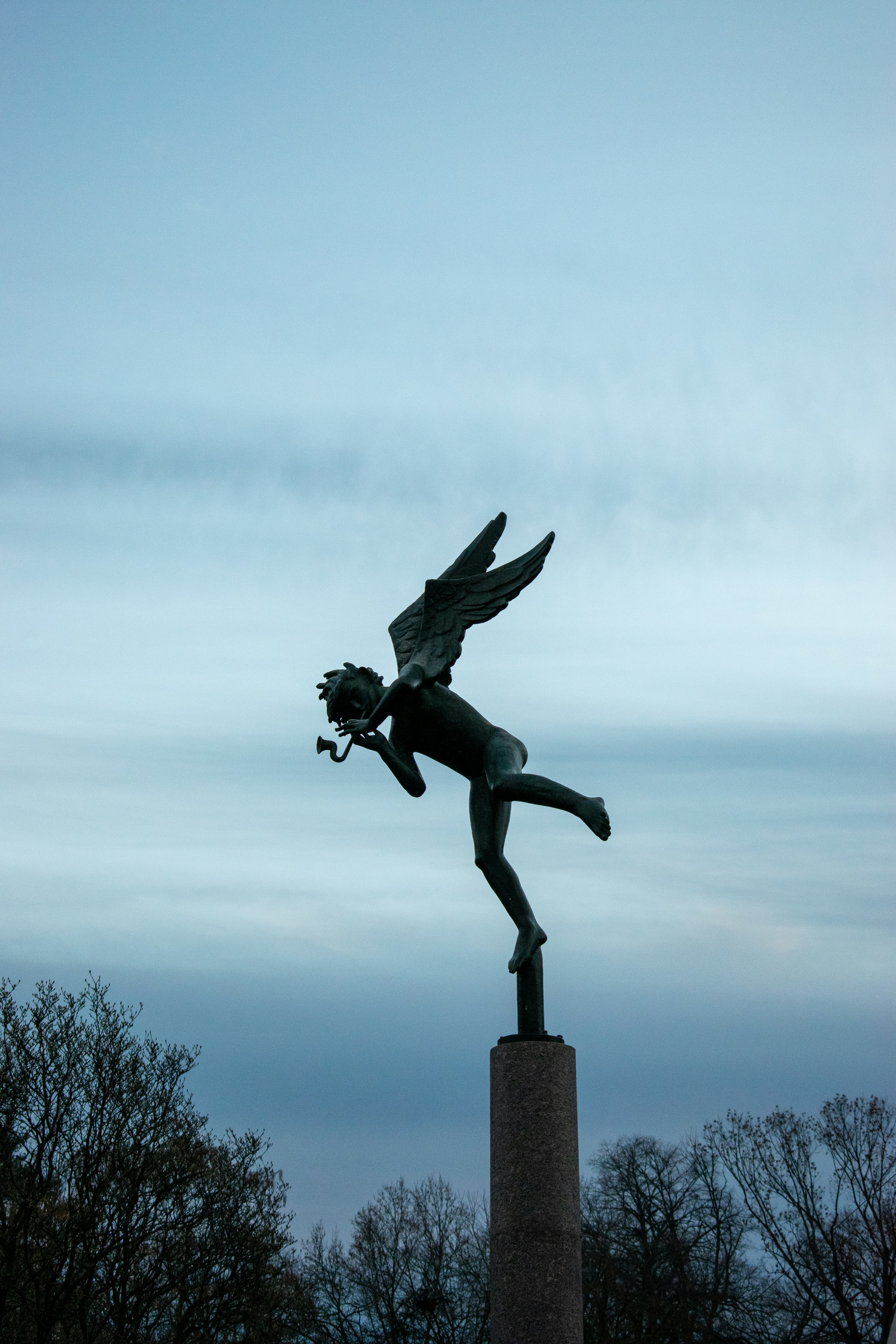 a statue of a woman with a flower in her hand