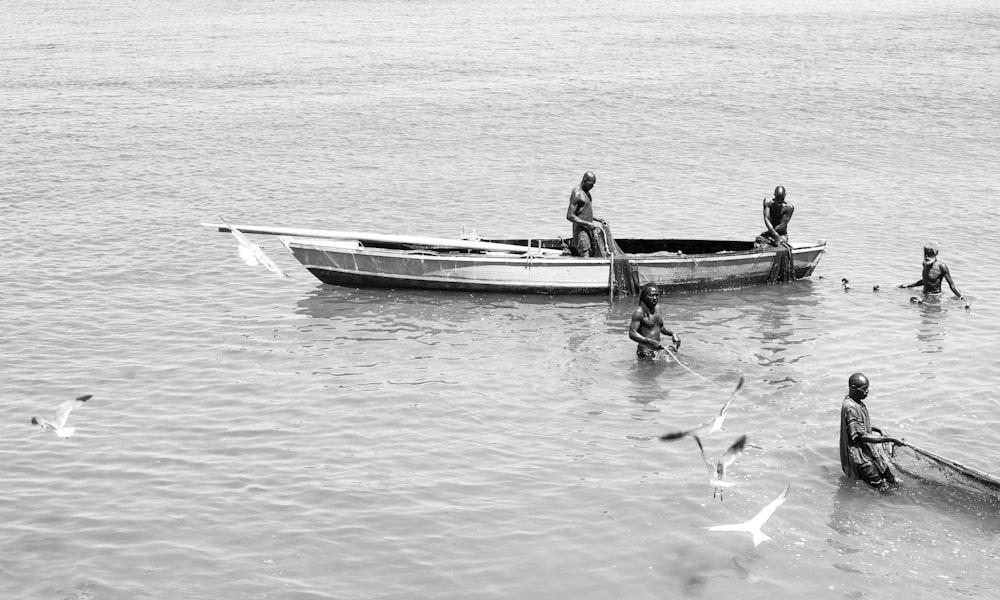 a black and white photo of a group of people in a boat
