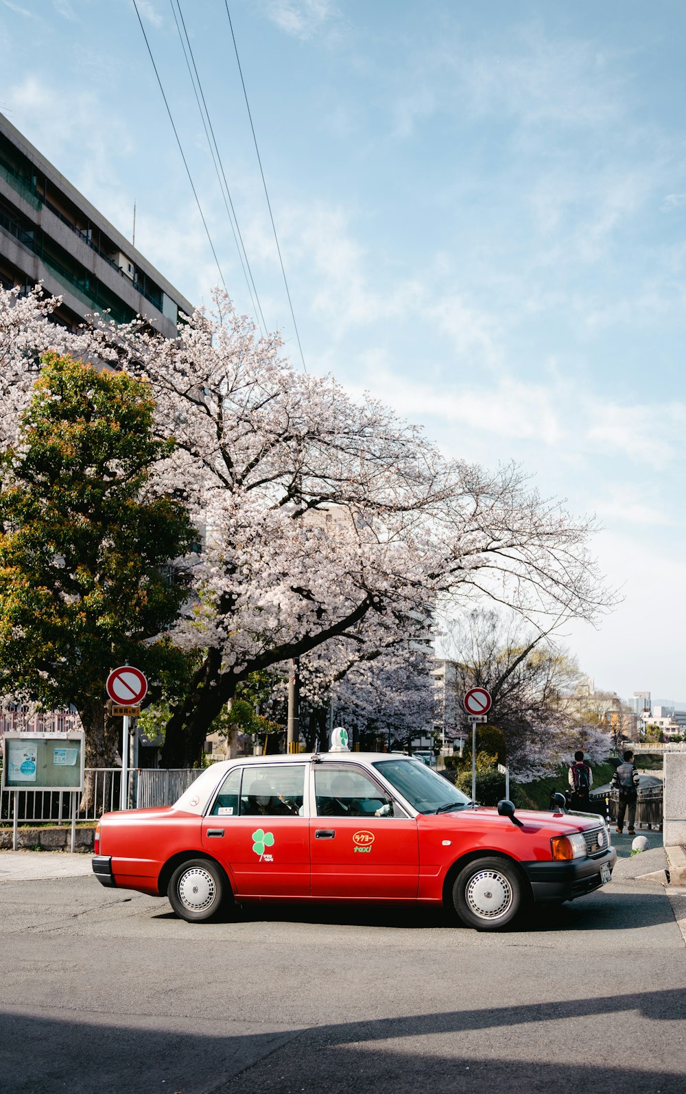 a red taxi cab parked on the side of the road