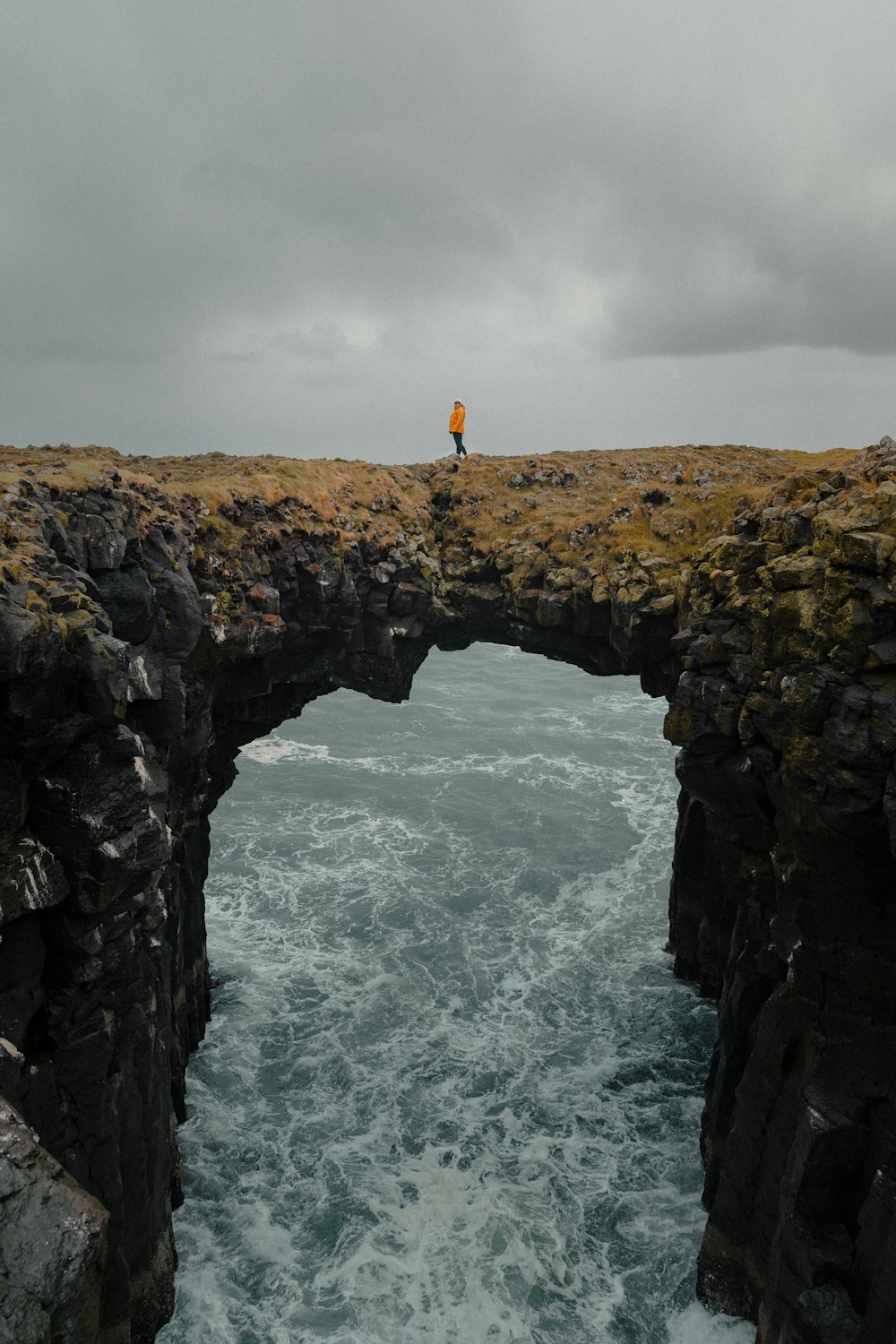 a person standing on a bridge over a body of water