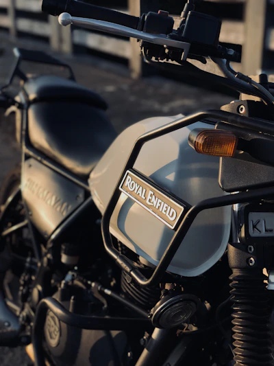A close-up shot of a vintage Royal Enfield with gleaming chrome details under soft street lights.