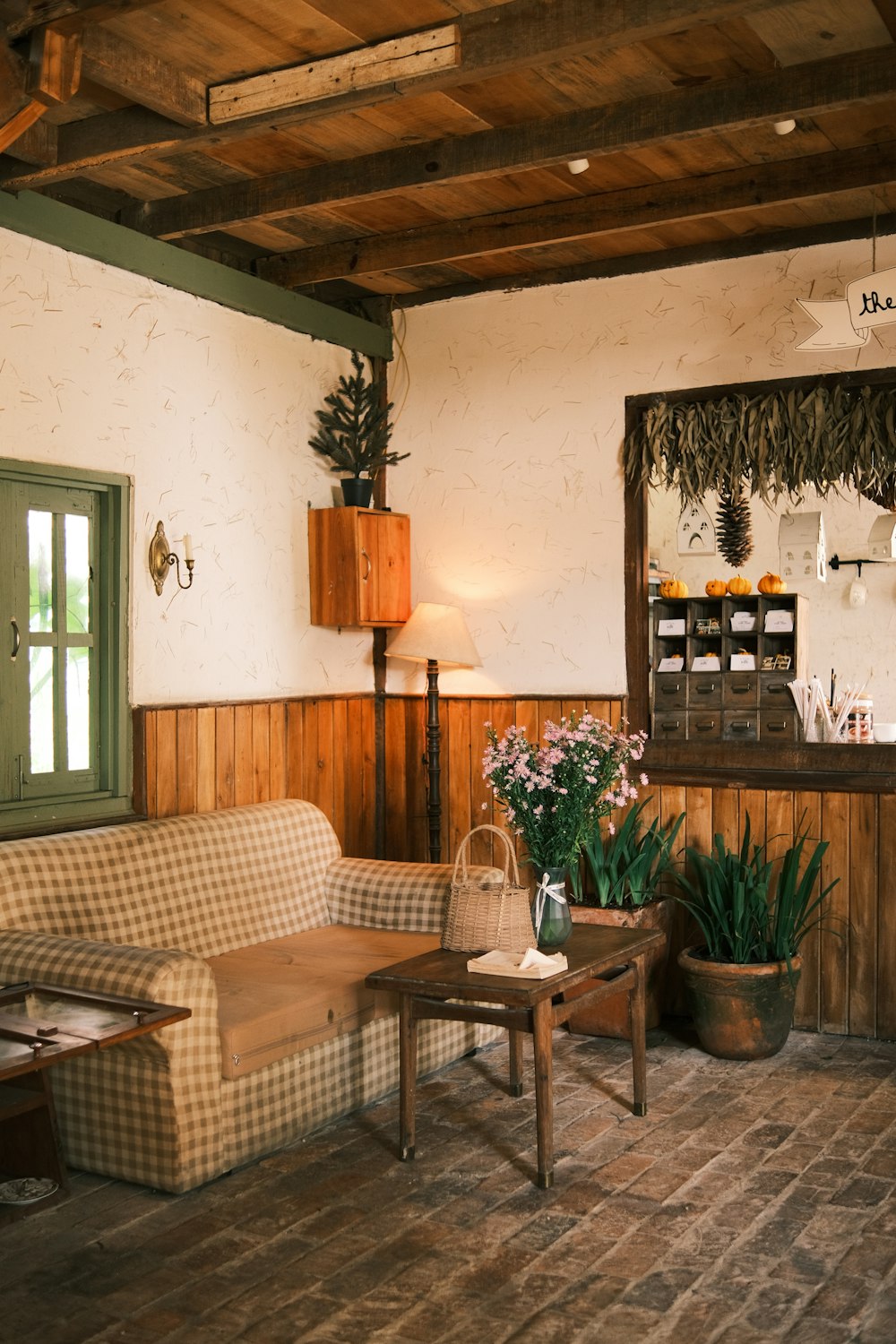 a living room filled with furniture and a wooden ceiling