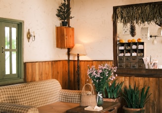 a living room filled with furniture and a wooden ceiling