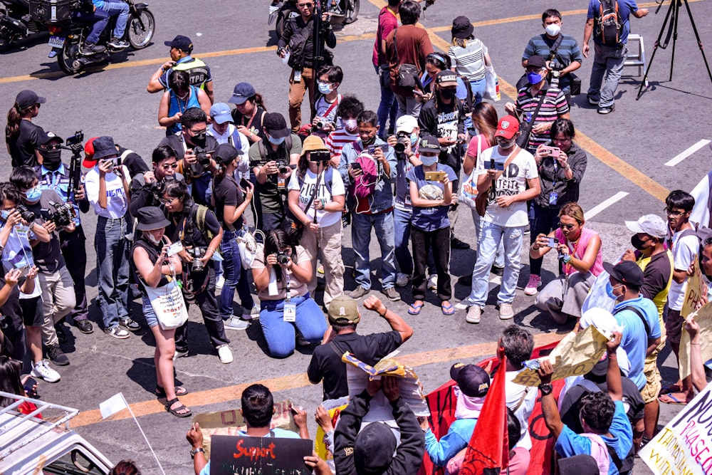 a crowd of people standing around each other