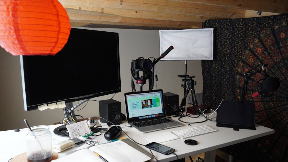 a laptop computer sitting on top of a white desk