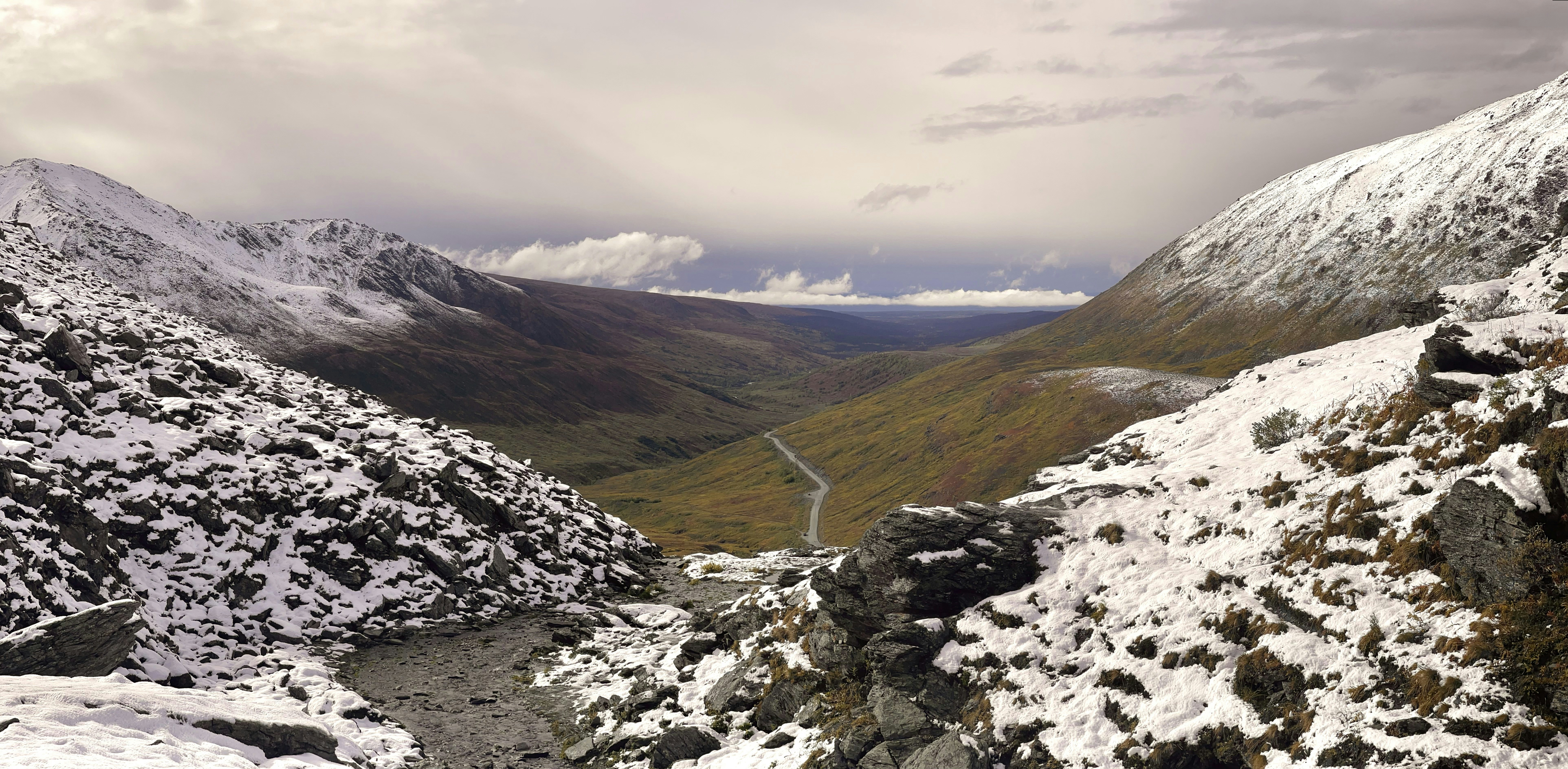 a view of a snowy mountain with a winding road