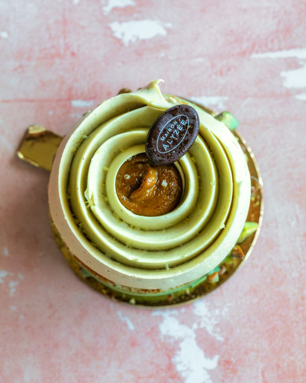 a cup of food with a cookie on top of it