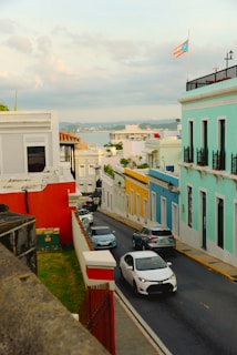 a city street with cars parked on both sides of the street
