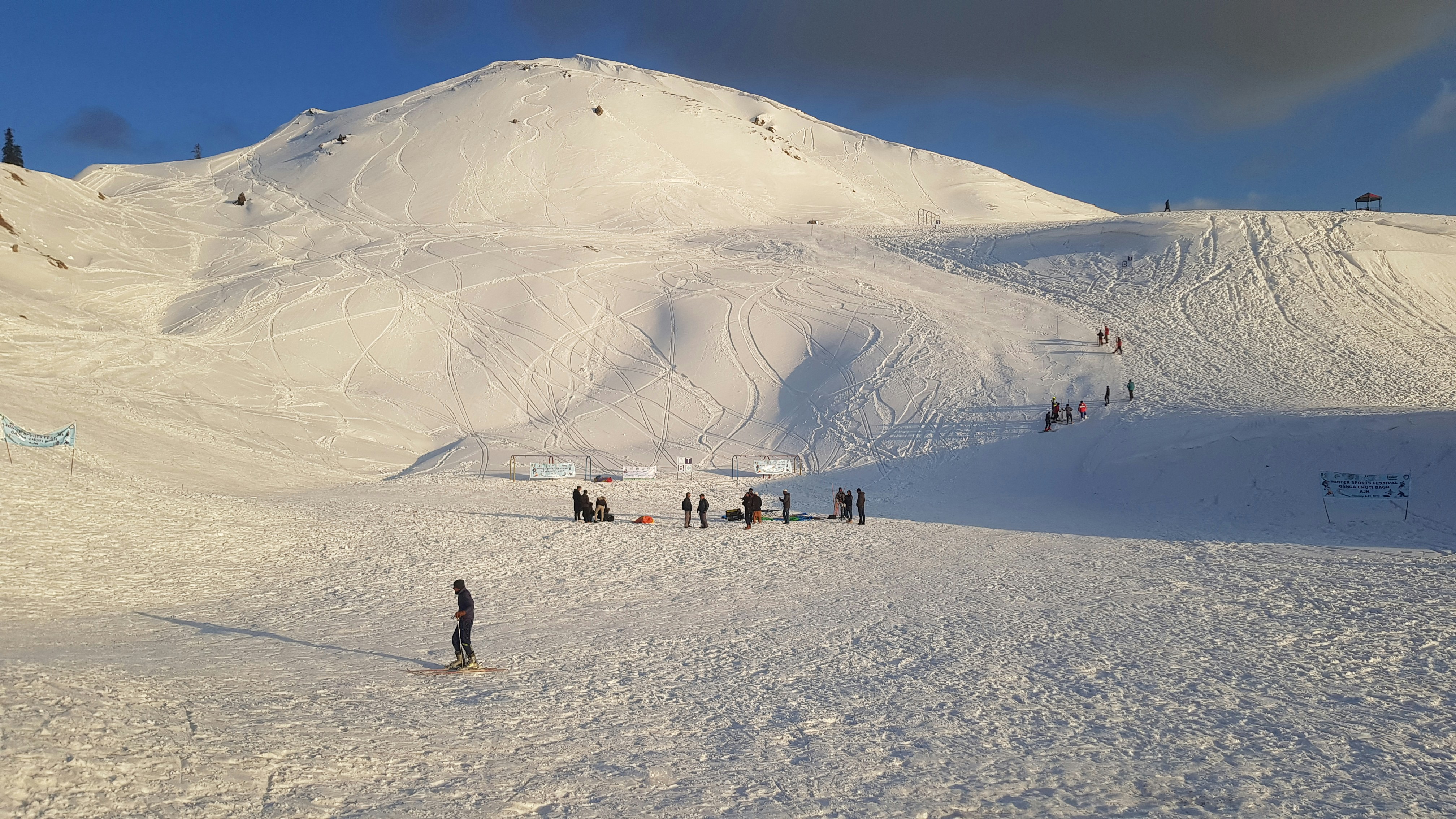 a group of people standing on top of a snow covered slope