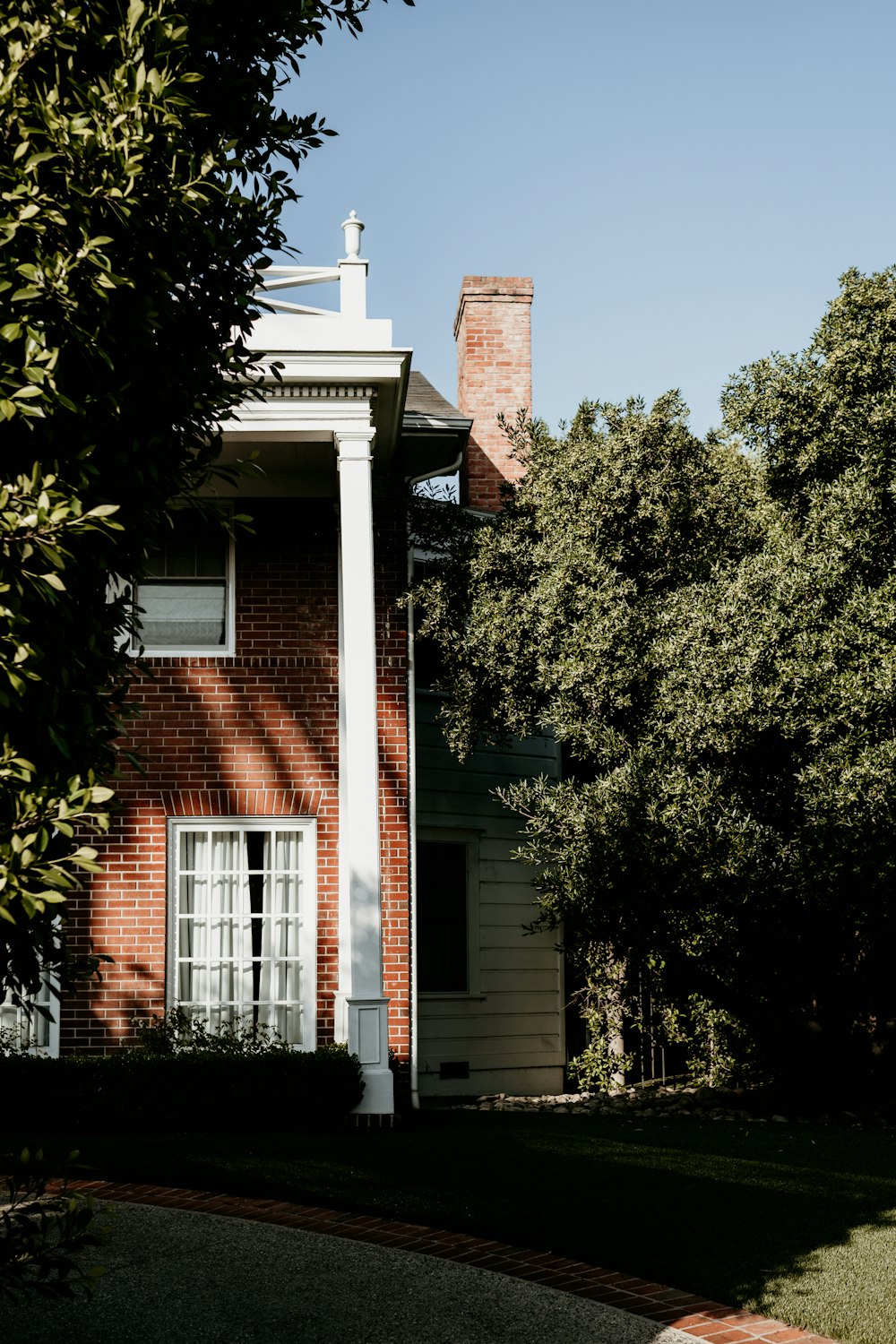 a brick house with a white cross on the top of it