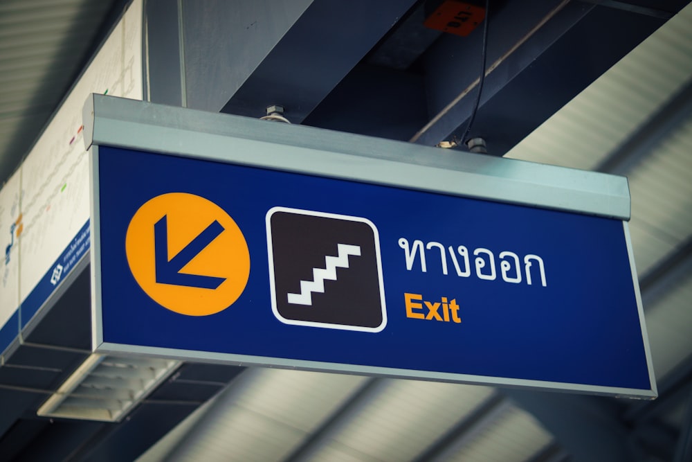 a blue sign hanging from the side of a building