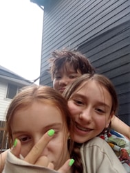A group of kids laughing and playing with nail smell products surrounded by pastel sparkles.
