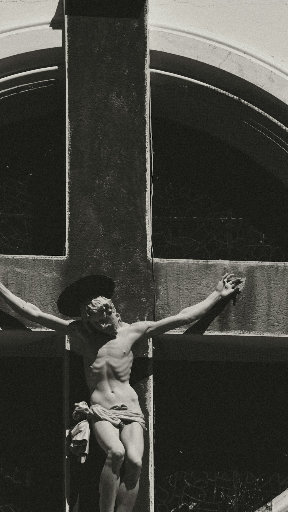 a black and white photo of a man on a cross
