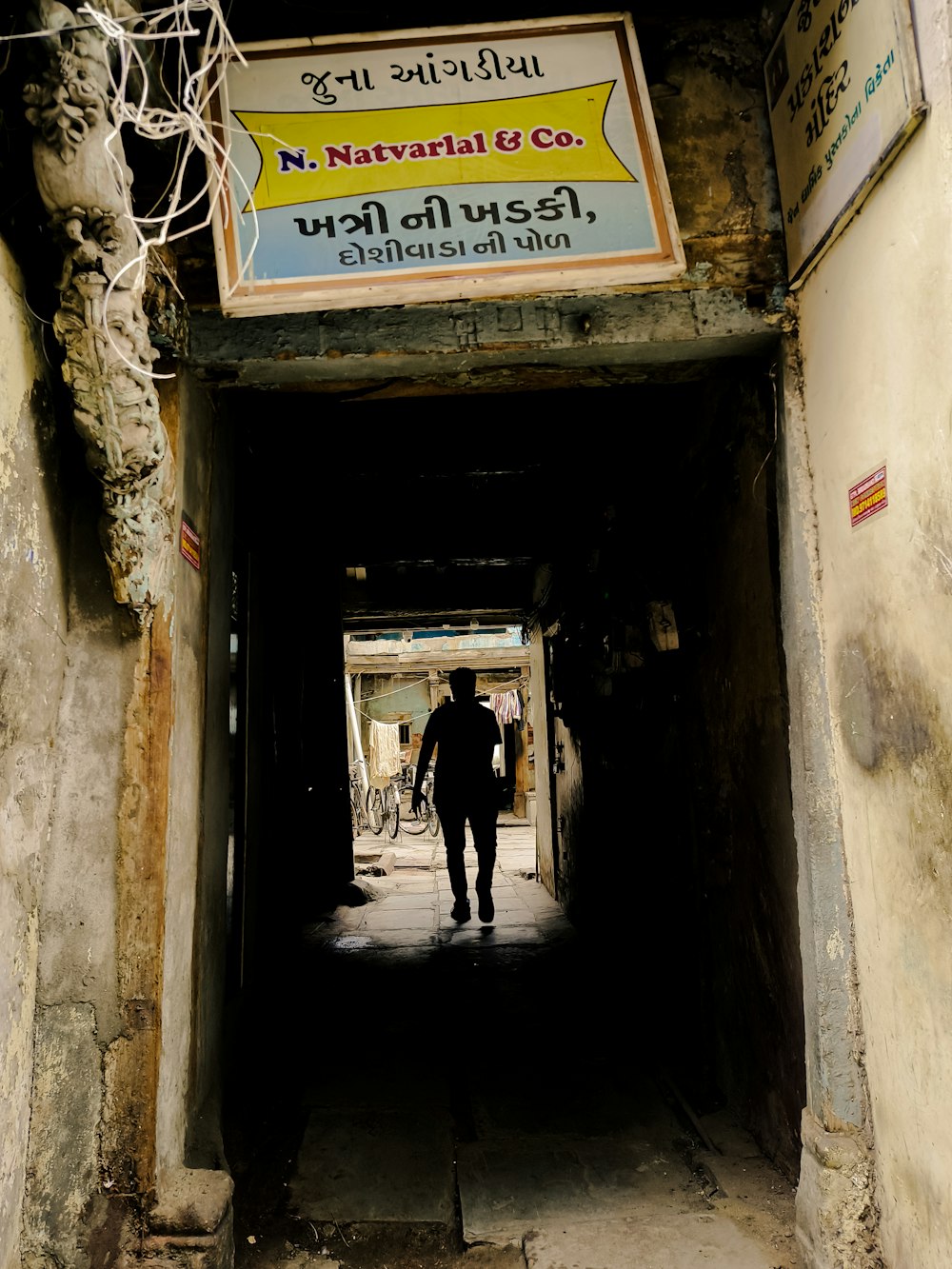 a man walking through a tunnel in a building