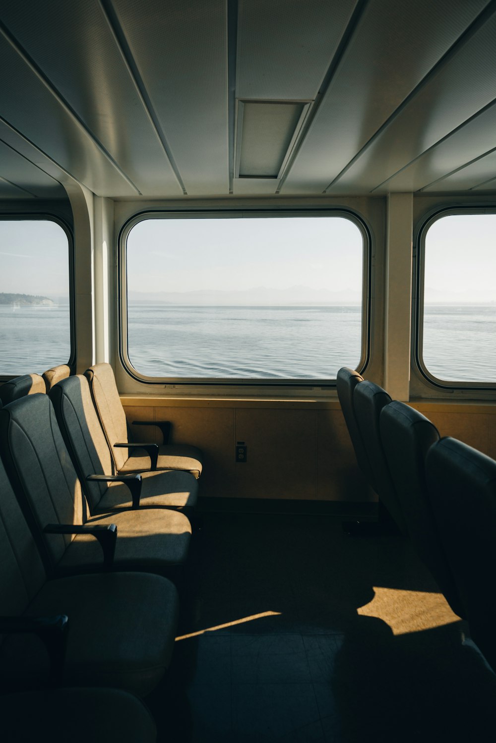 a row of seats sitting on top of a train next to a window