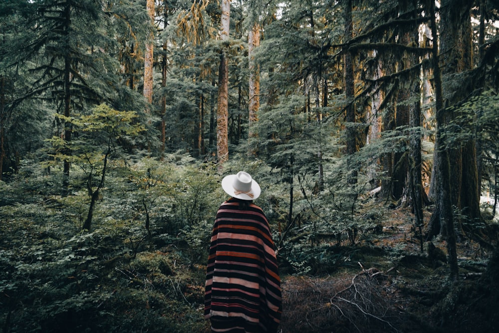 a person standing in the middle of a forest